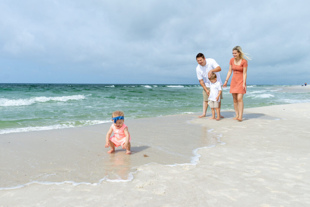family playing on beach
