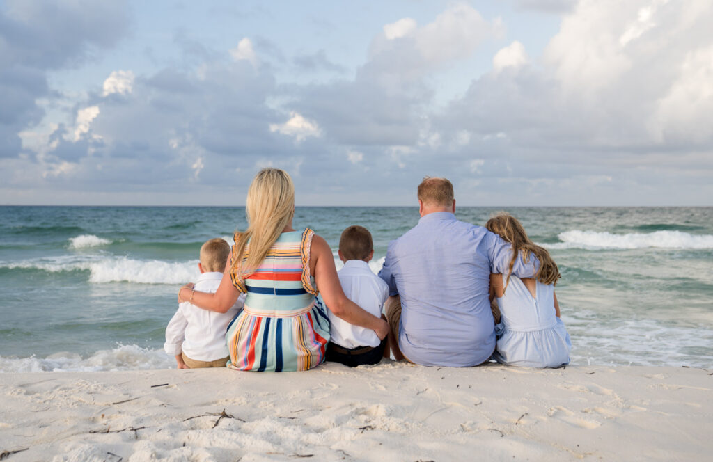 family facing Gulf of Mexico