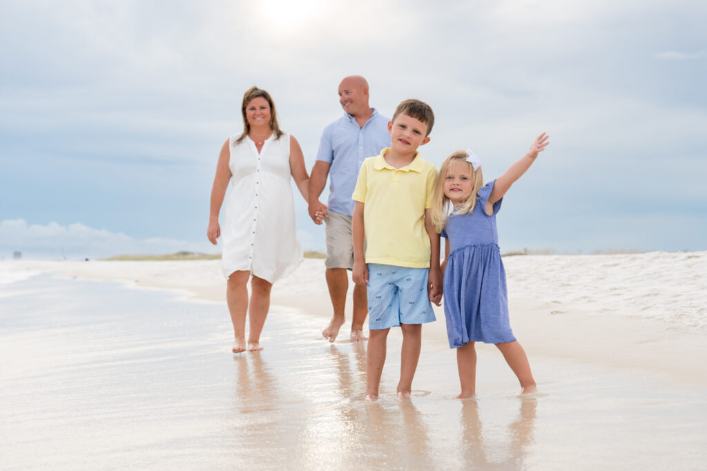 family walking down beach