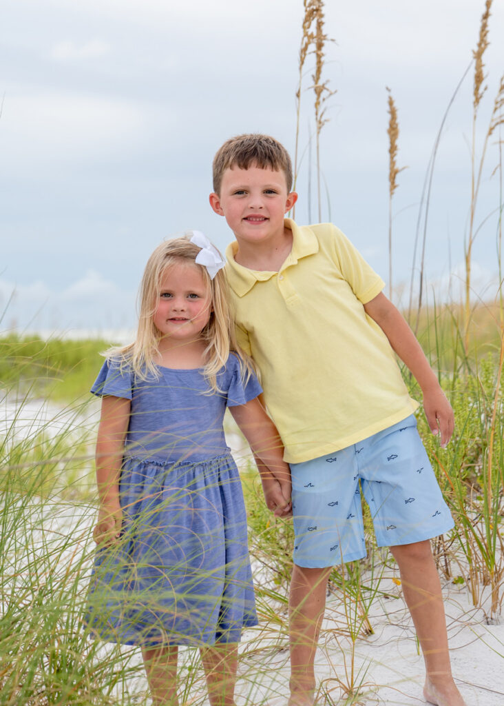 brother and sister behind sea oats