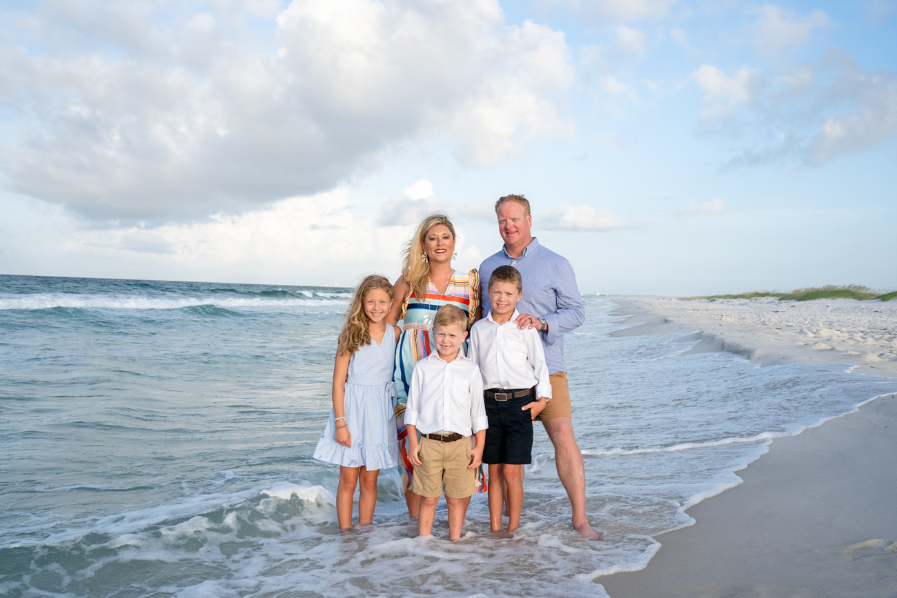 family standing near ocean
