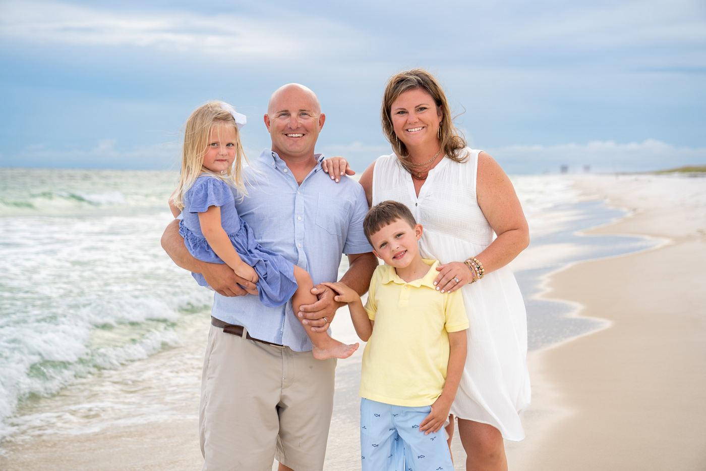 A family posing for a picture on the beach