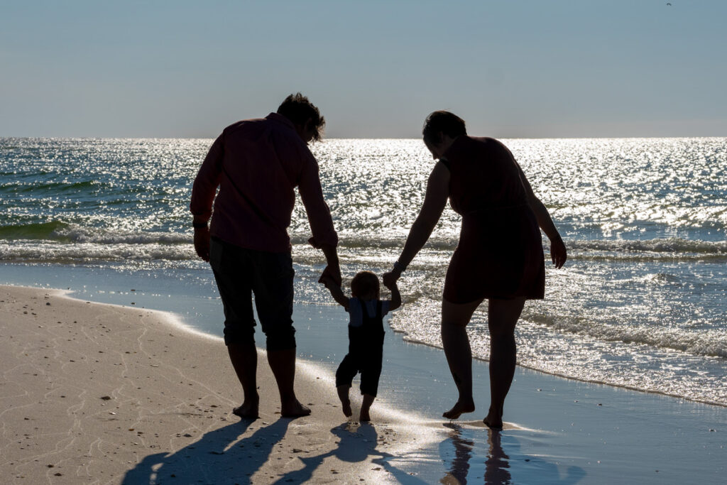 silhouette of family on beach