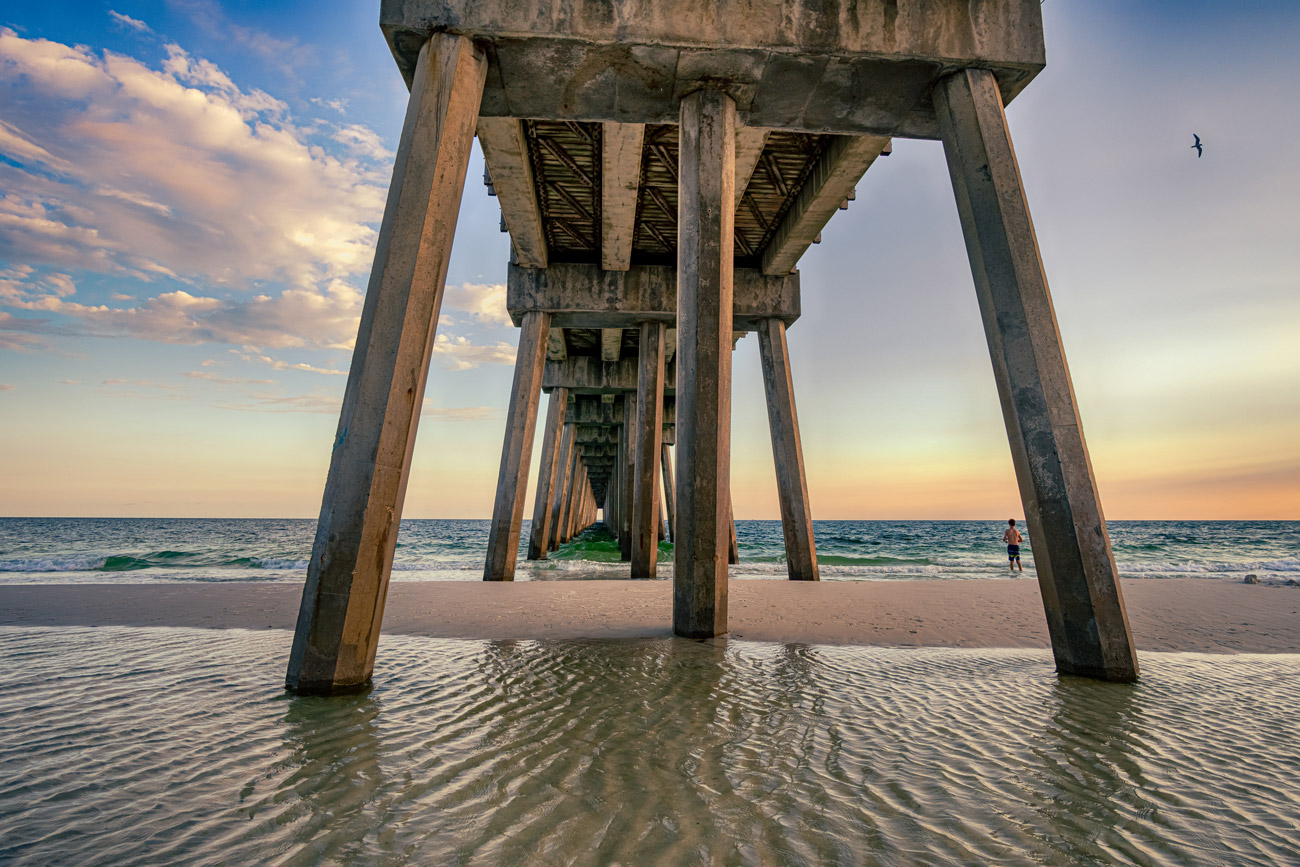 A pier that has some water underneath it