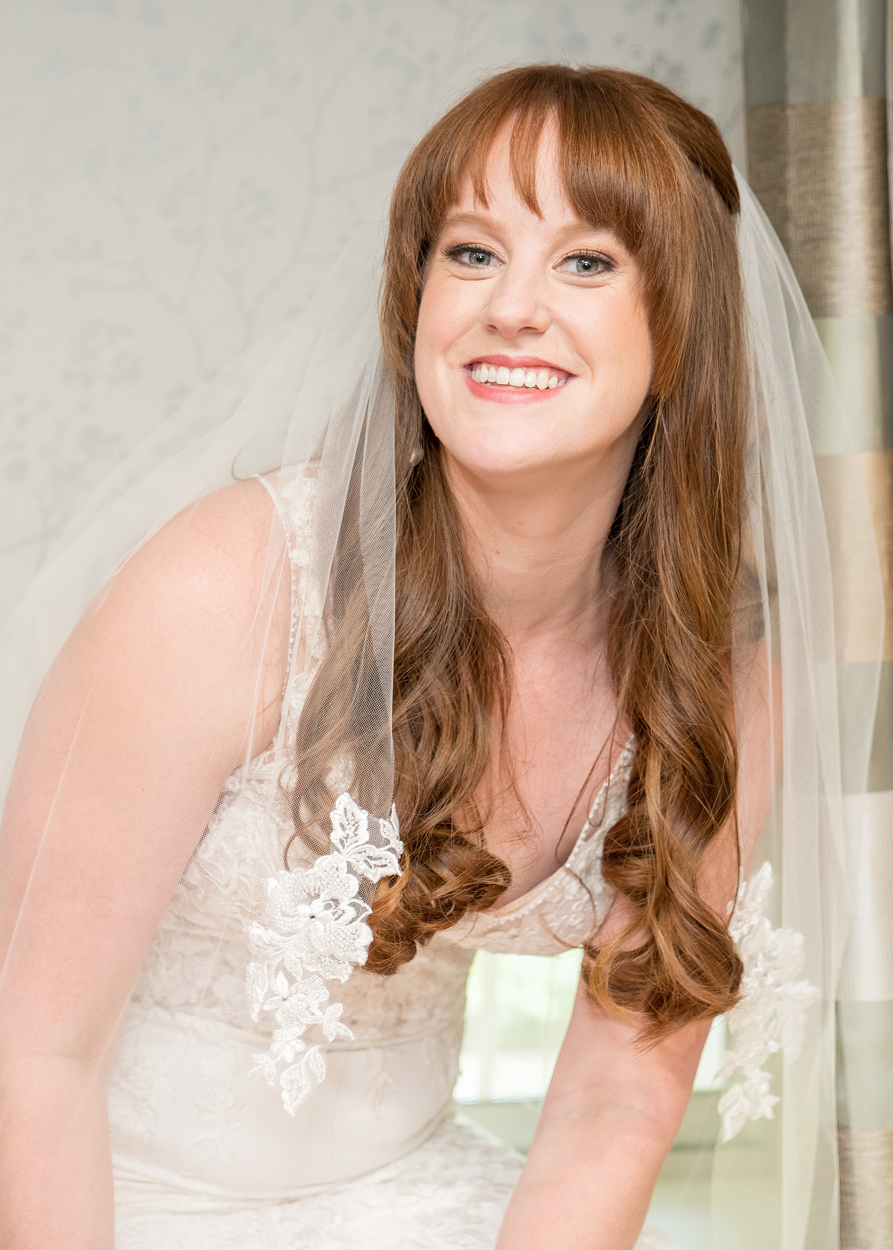 A woman with long hair and a veil on her head.