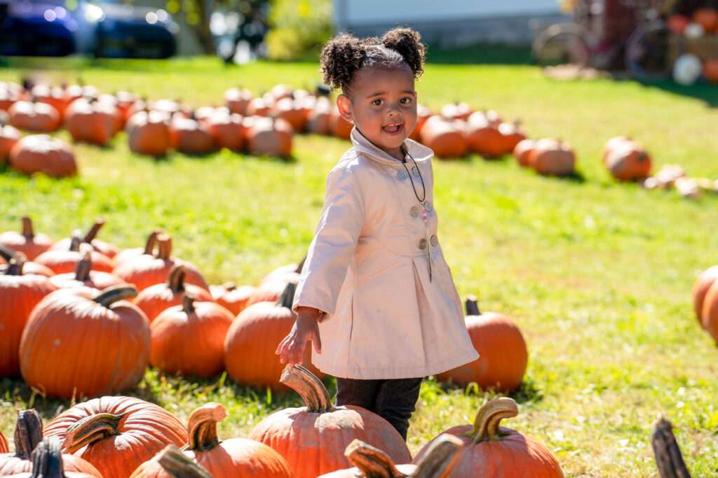 girl standing in pumpkin patch