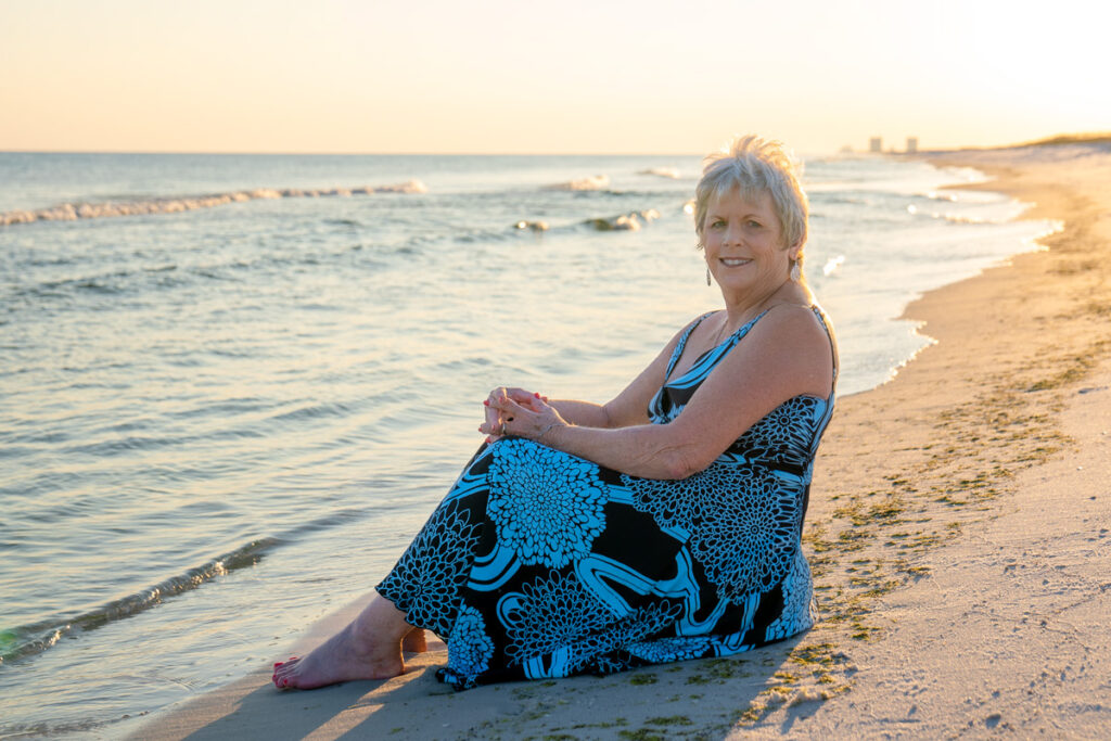 lady sitting along shore