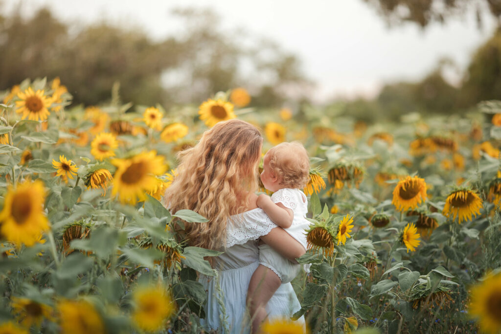 mother and daughter in sunflower field