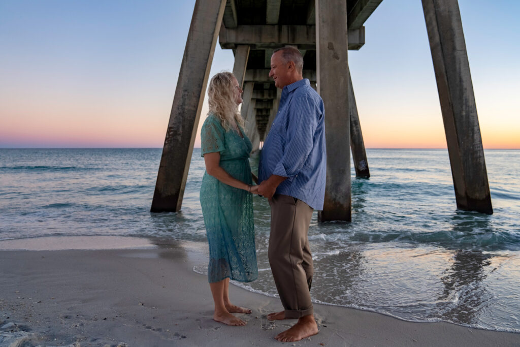 couple hand in hand at navarre pier