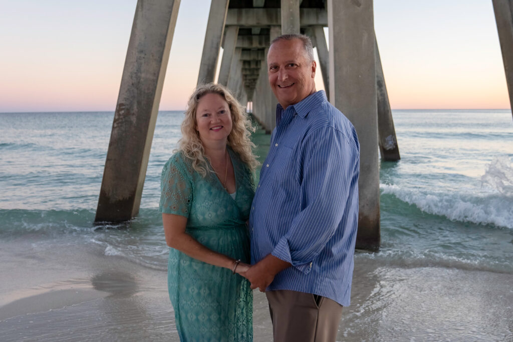 couple holding hands at navarre pier