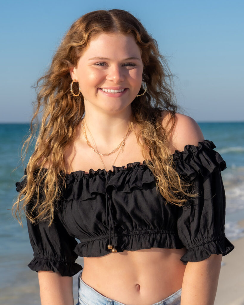 A woman with long hair and a black top