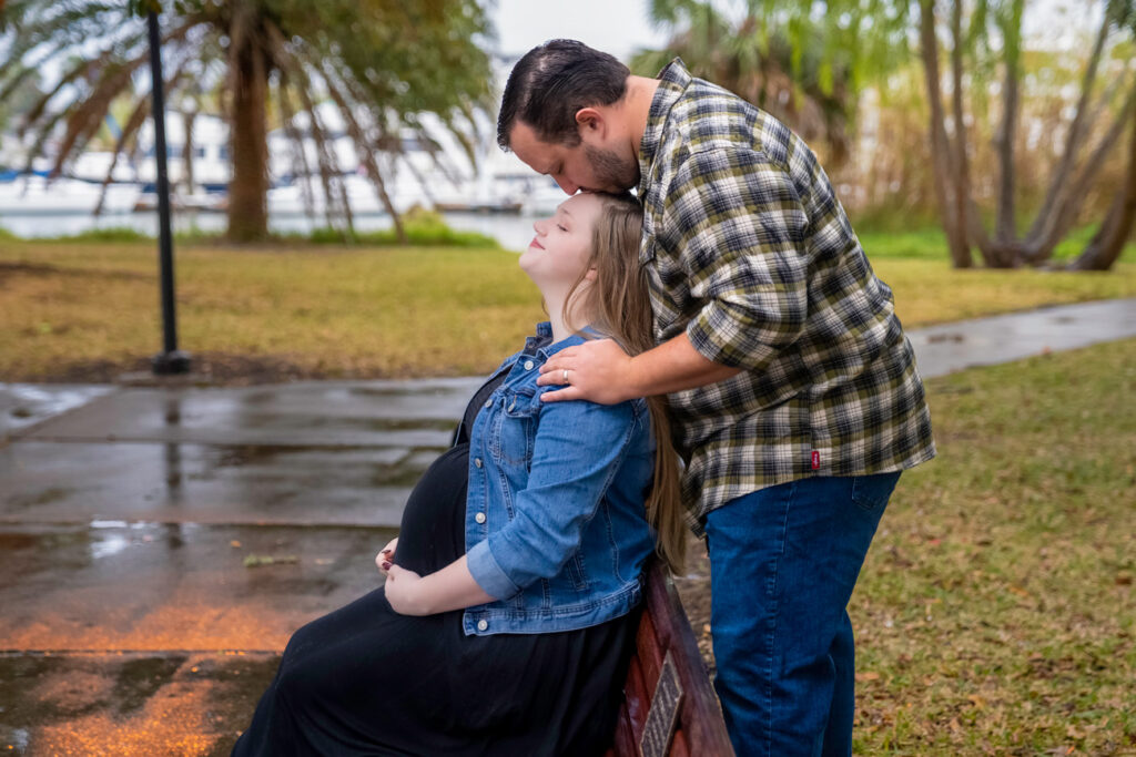 pregnant woman and husband on park bench