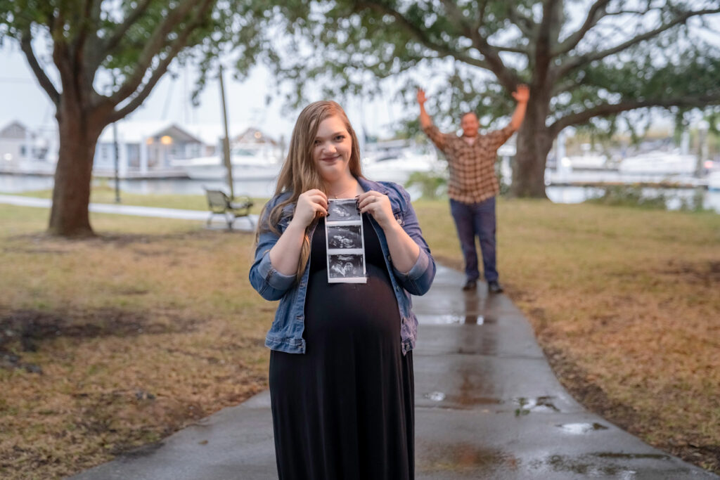 pregnant woman holding sonogram picture