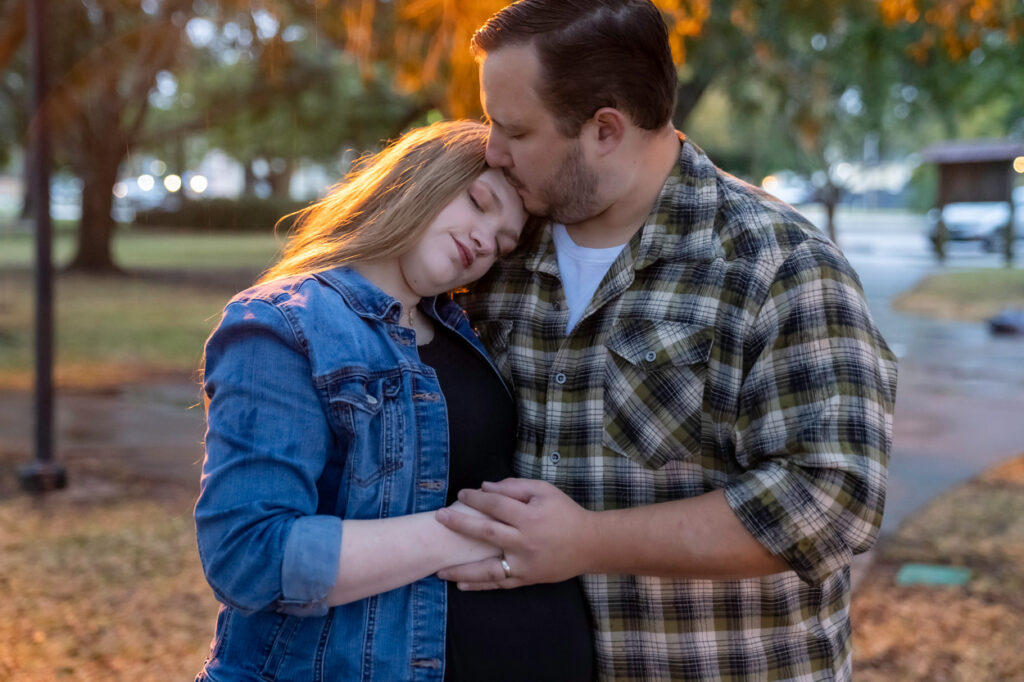 pregnant woman and husband kissing
