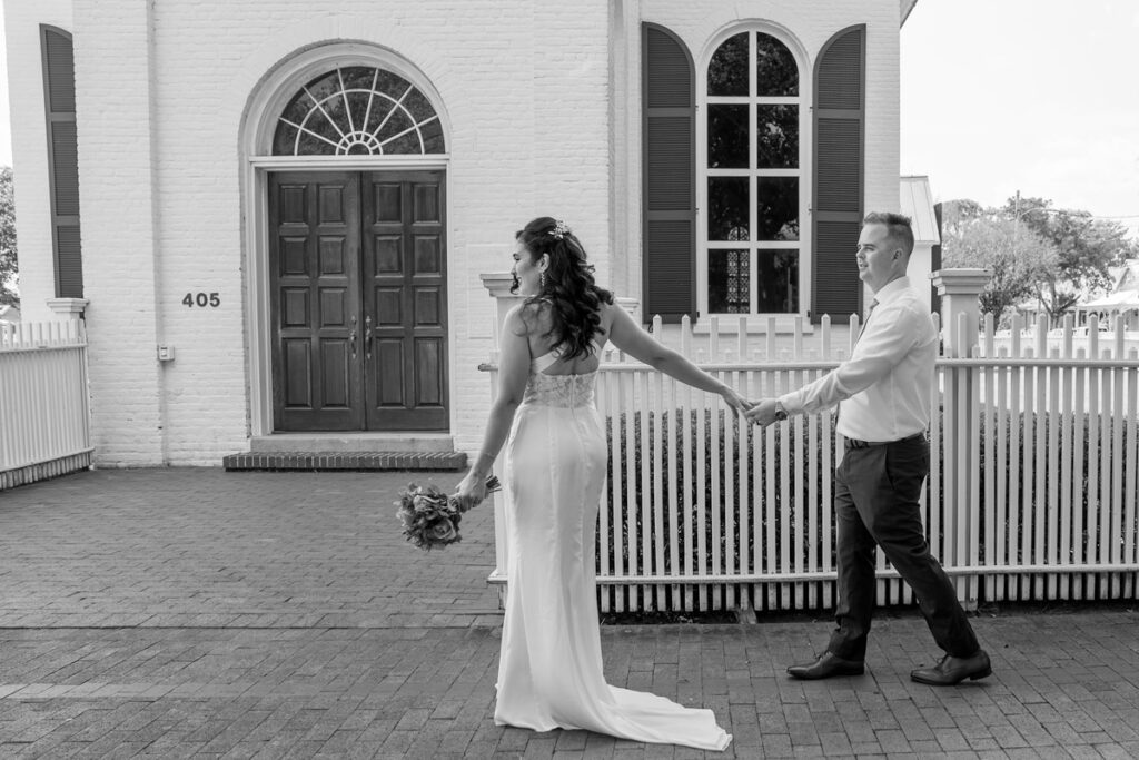bride-and-groom-walking-past-church